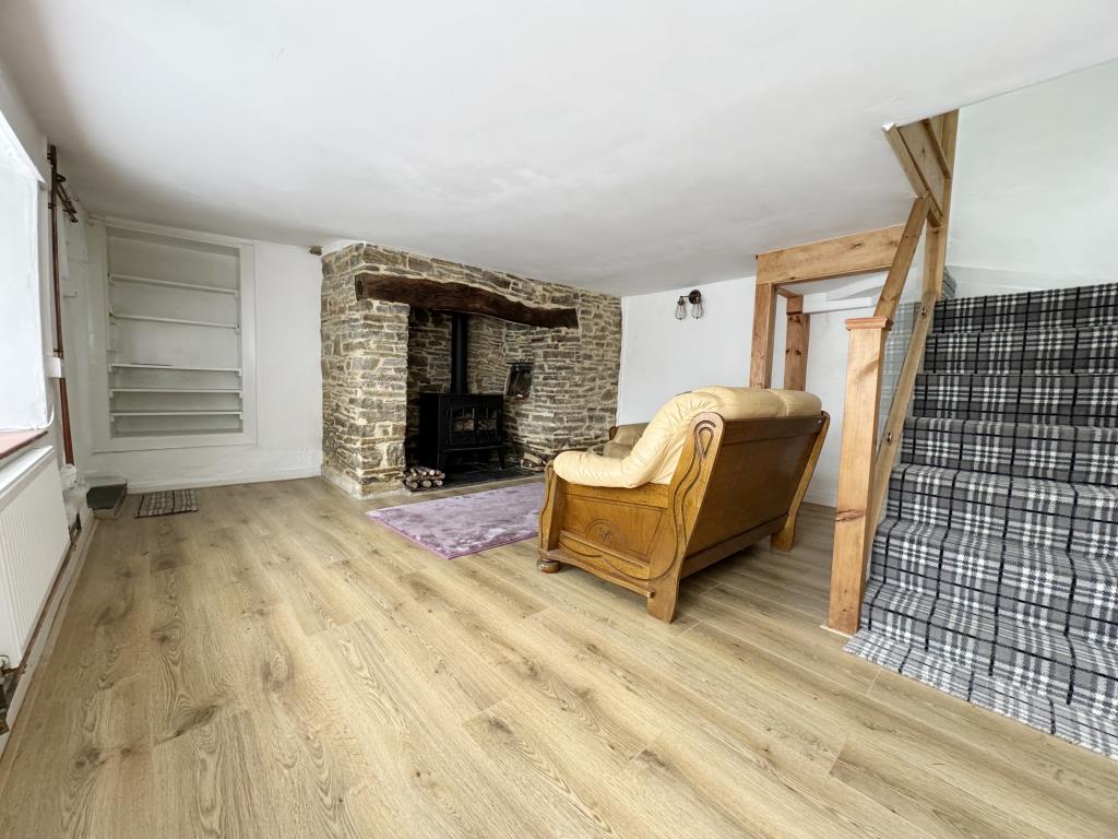 Lot: 97 - TWO-BEDROOM COTTAGE WITH PARKING IN PICTURESQUE VILLAGE - Sitting room with Inglenook fire place